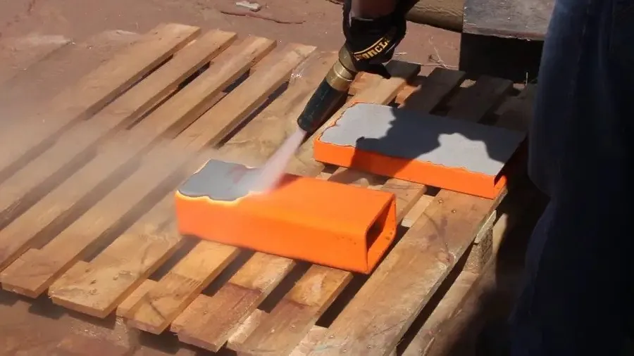 Dustless blasting a coating off timber