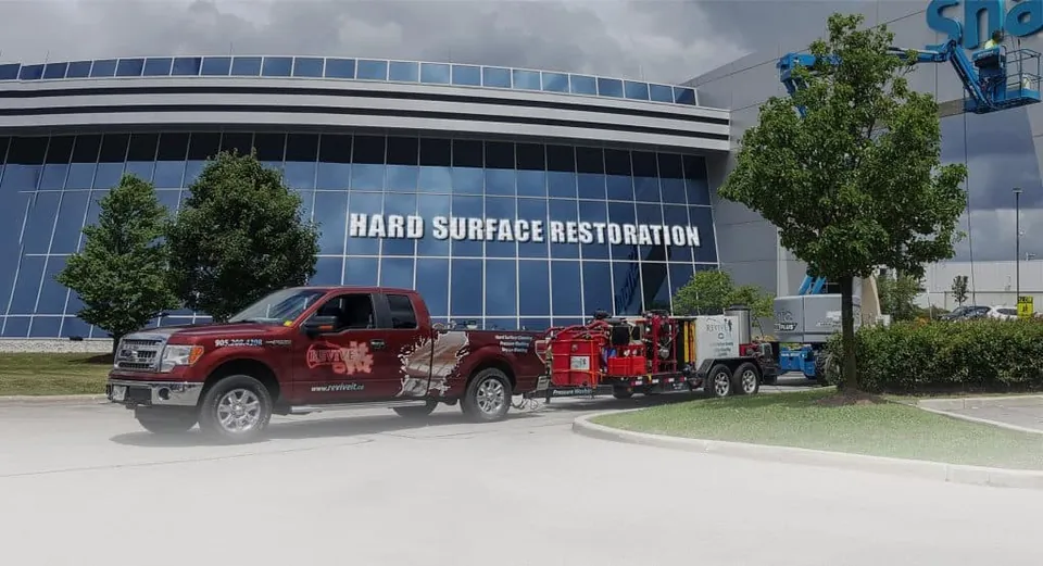 Revive trucks and wash trailers outside the Hard Surface Restoration shop